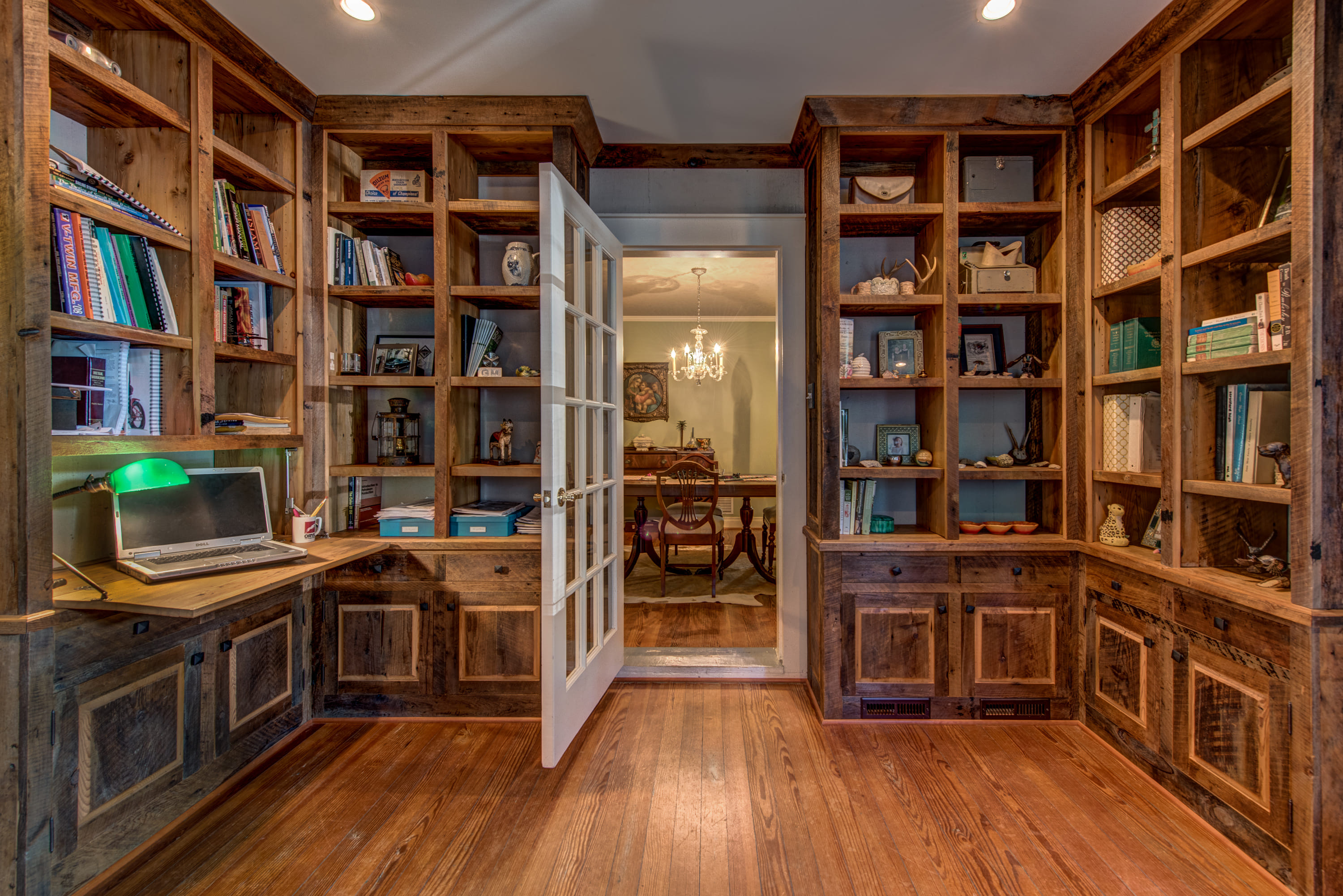 A cozy library with dark stained wooden shelves