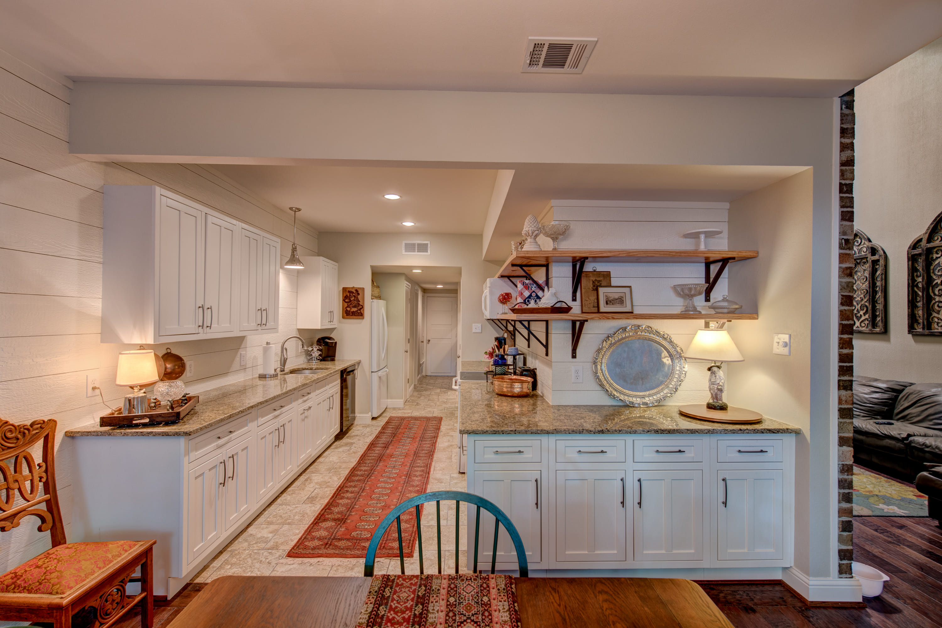 Long kitchen with bright white cabinets and popping pastel colors number 2.