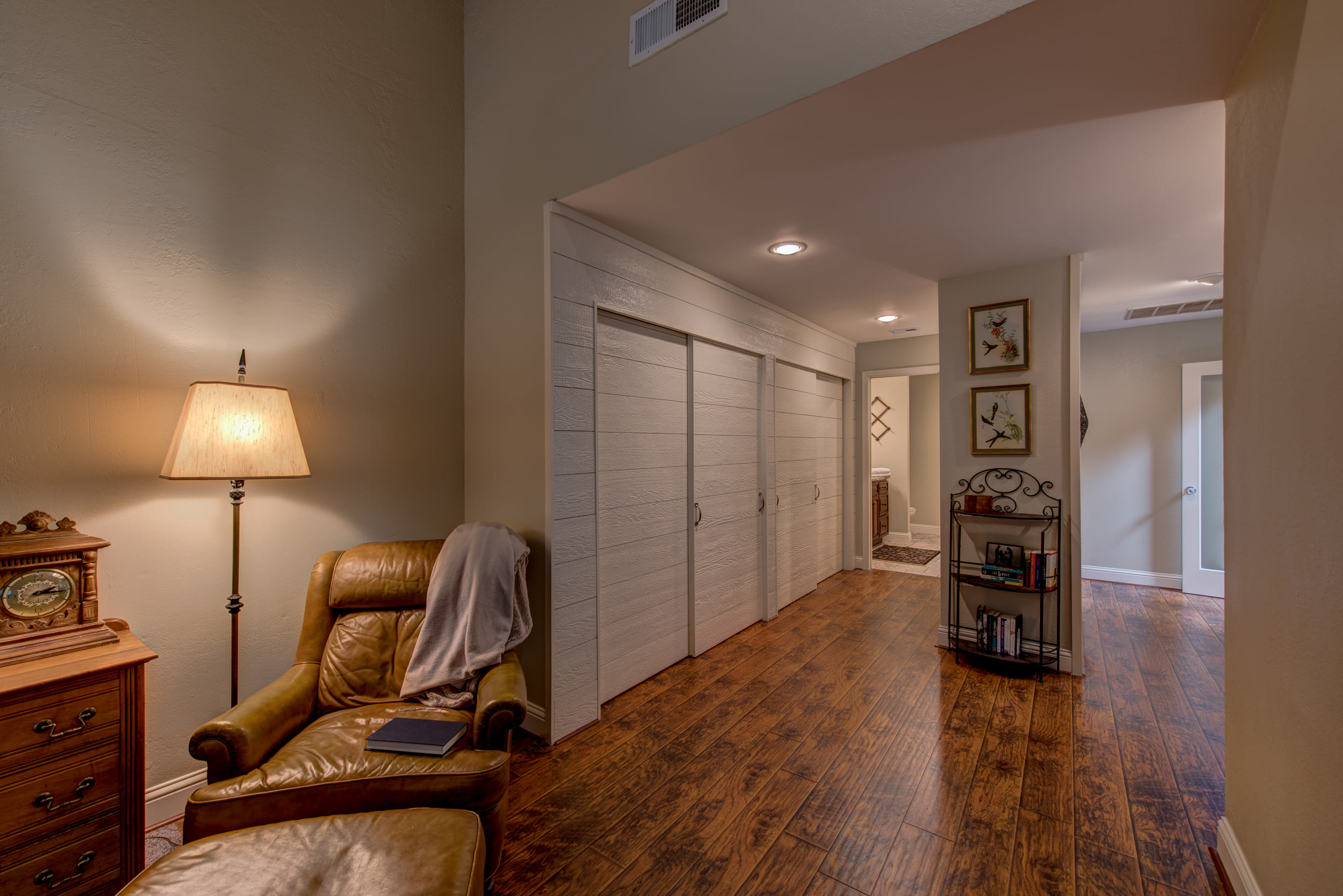 Master bedroom with a long series of closets.