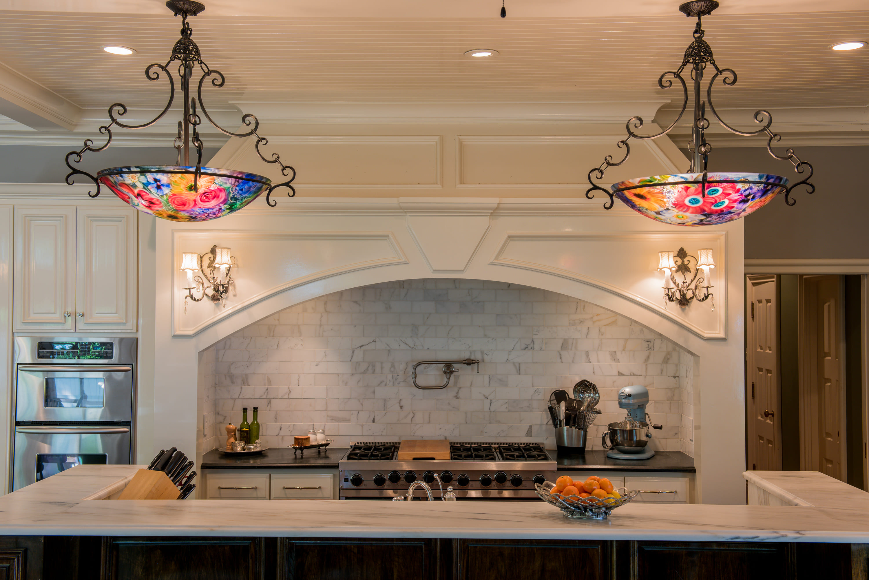 Beautiful kitchen with white granite counter top and stain glass lights