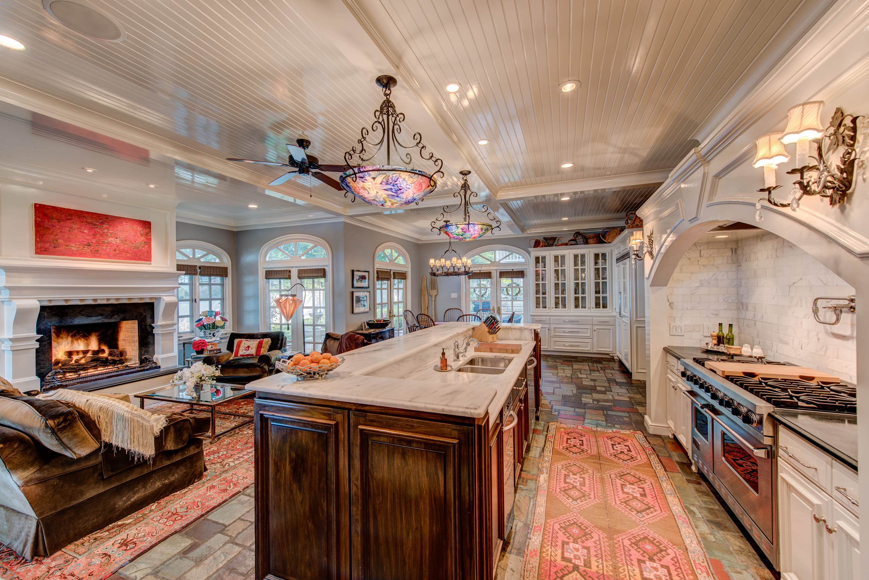 Kitchen with a large island and a cozy den.